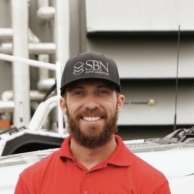 SBN team member in front of the transport truck