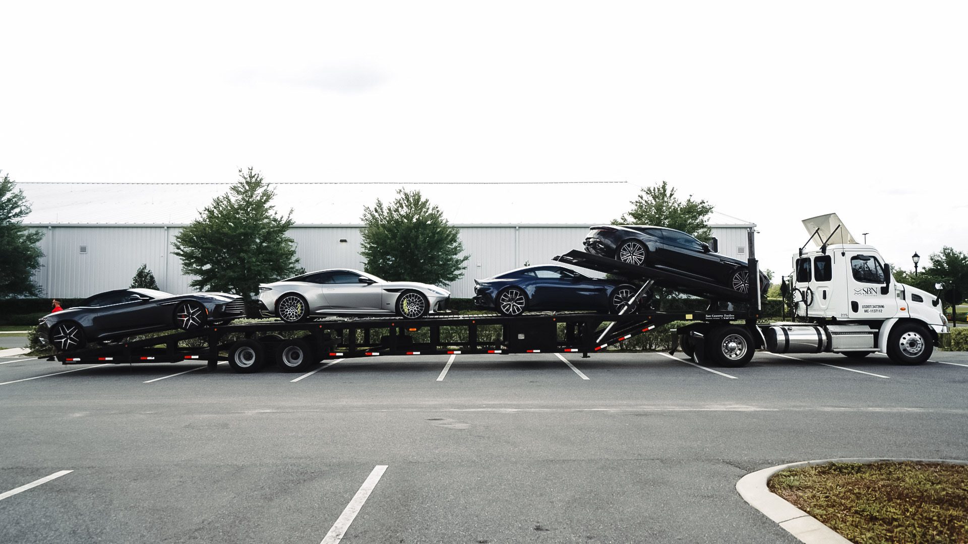 CrossCountry Connect — SBN truck and trailer loaded with Aston Martins